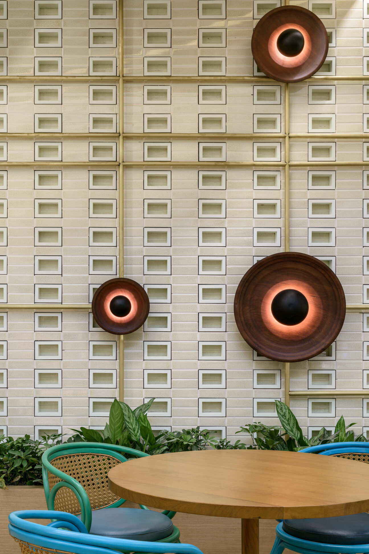 Colourful and asymmetrical sound plates dotted on a wall